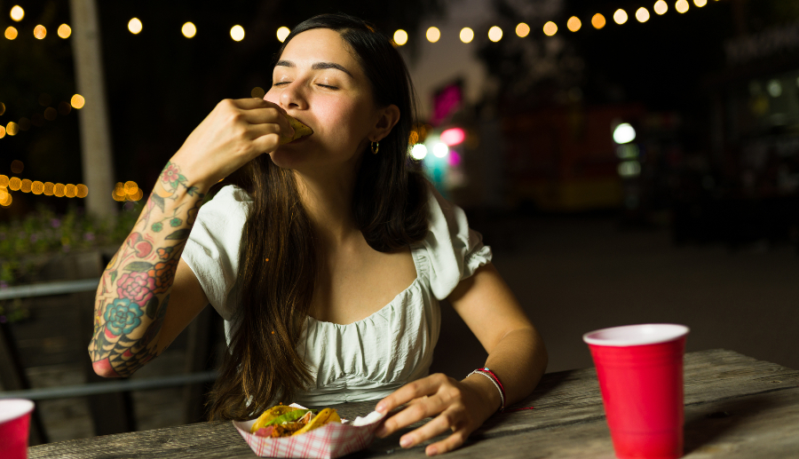 Mujer feliz comiendo comida mexicana