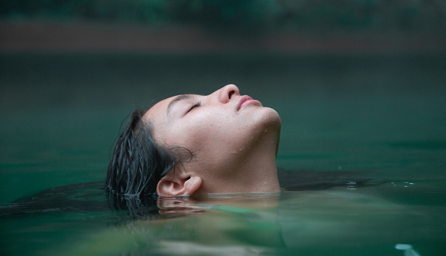 Rostro femenino sumergiéndose en las termas de Cajón del Maipo