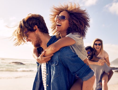 Grupo de parejas divirtiéndose en un día de playa